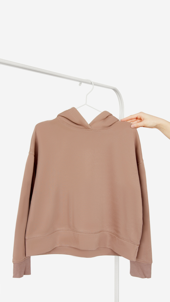 A Person Holding a Brown Hoodie